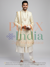 Man wearing a cream sherwani with gold embroidery on a gray background, featuring the PurvX India logo.