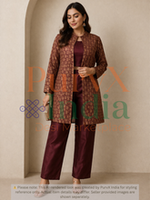 Woman wearing a maroon brocade jacket with silk bustier top and matching pants with a beige background, featuring the brand 'PurvX India'.