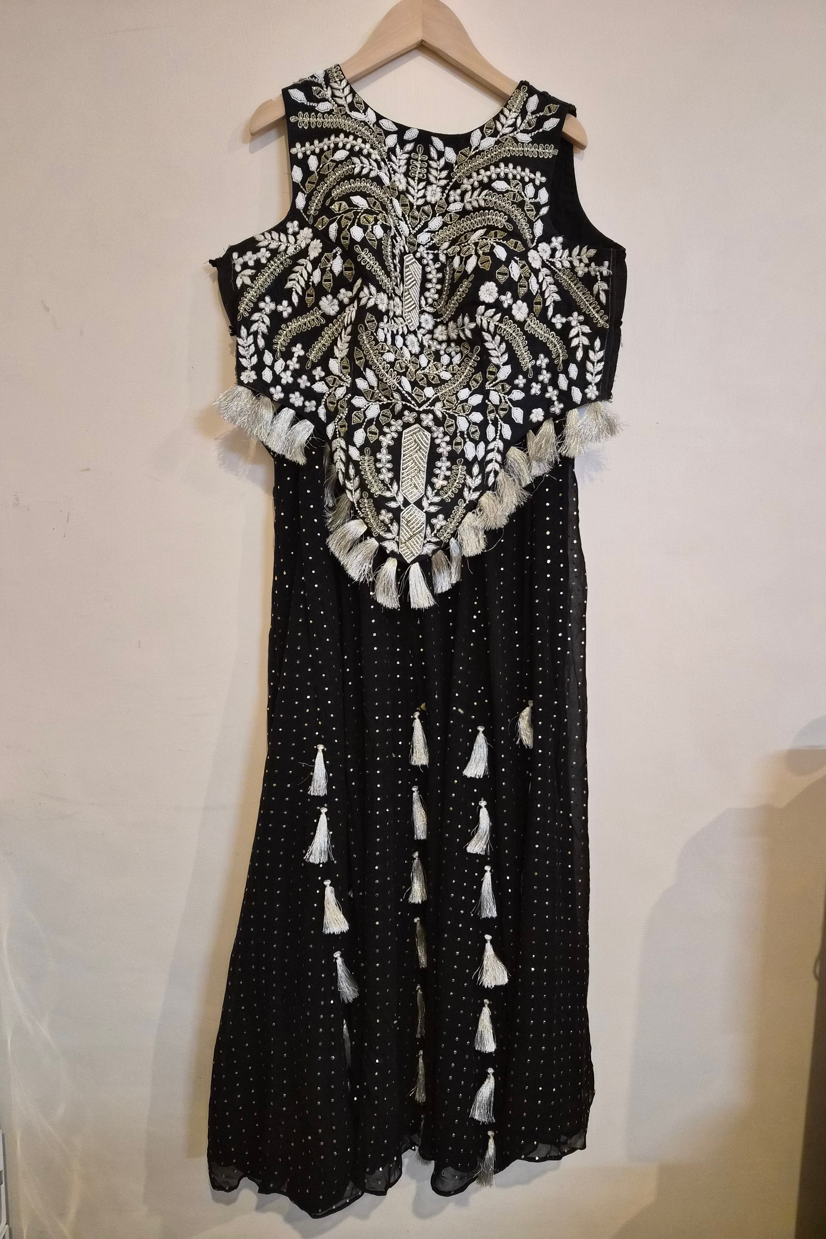 Black and white dress with intricate patterns on a plain background