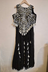 Black and white dress with intricate patterns on a plain background