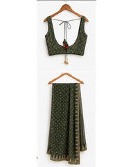 A dark green printed two-piece outfit consisting of a sleeveless tie-neck blouse and matching wide-leg pants, displayed on wooden hangers against a white background.