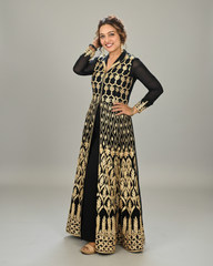 Woman wearing a black and gold patterned gown on a gray background
