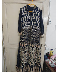 Navy blue and beige embroidered kurta hanging on a door