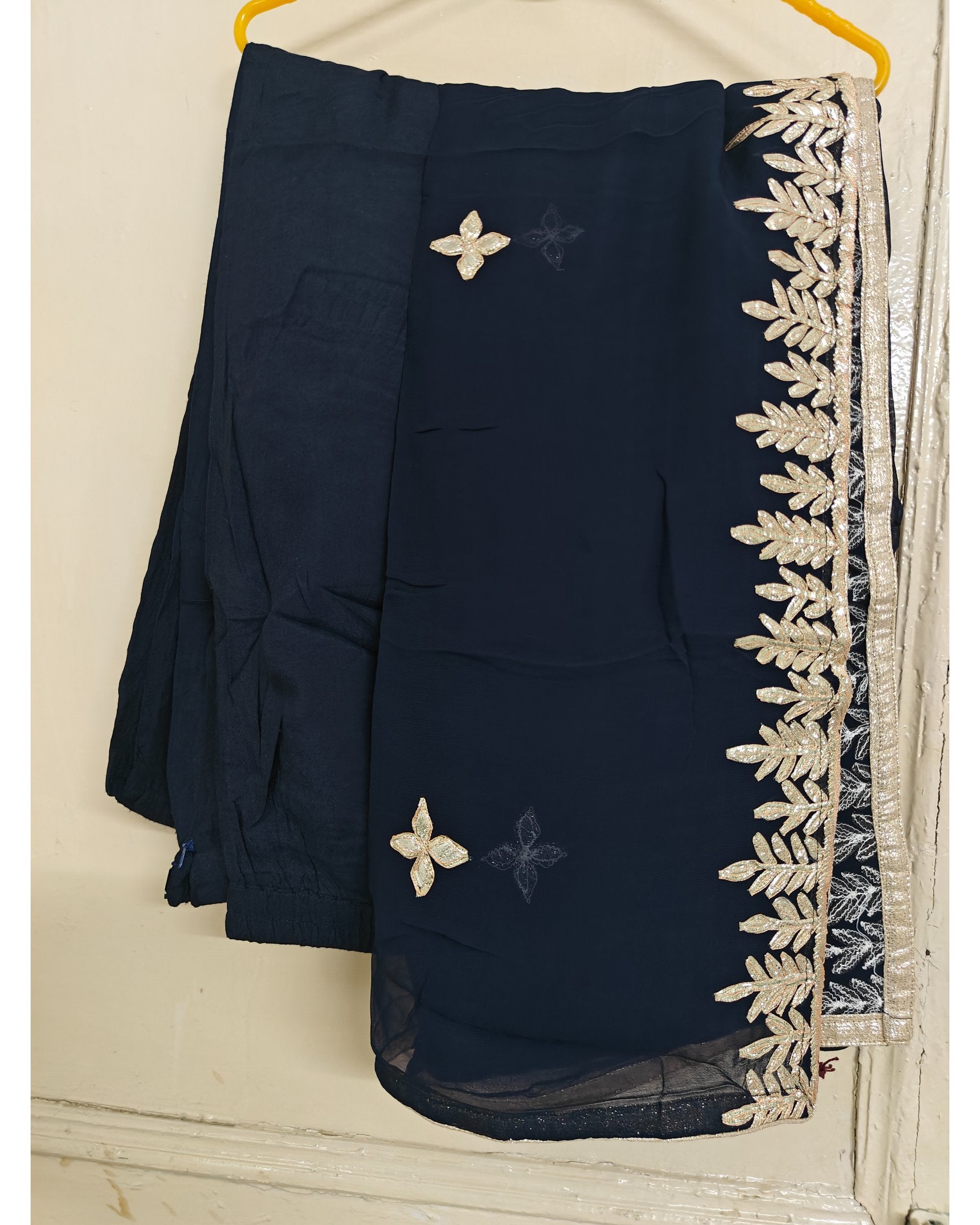 Navy blue dupatta with white floral embroidery on a hanger against a white background