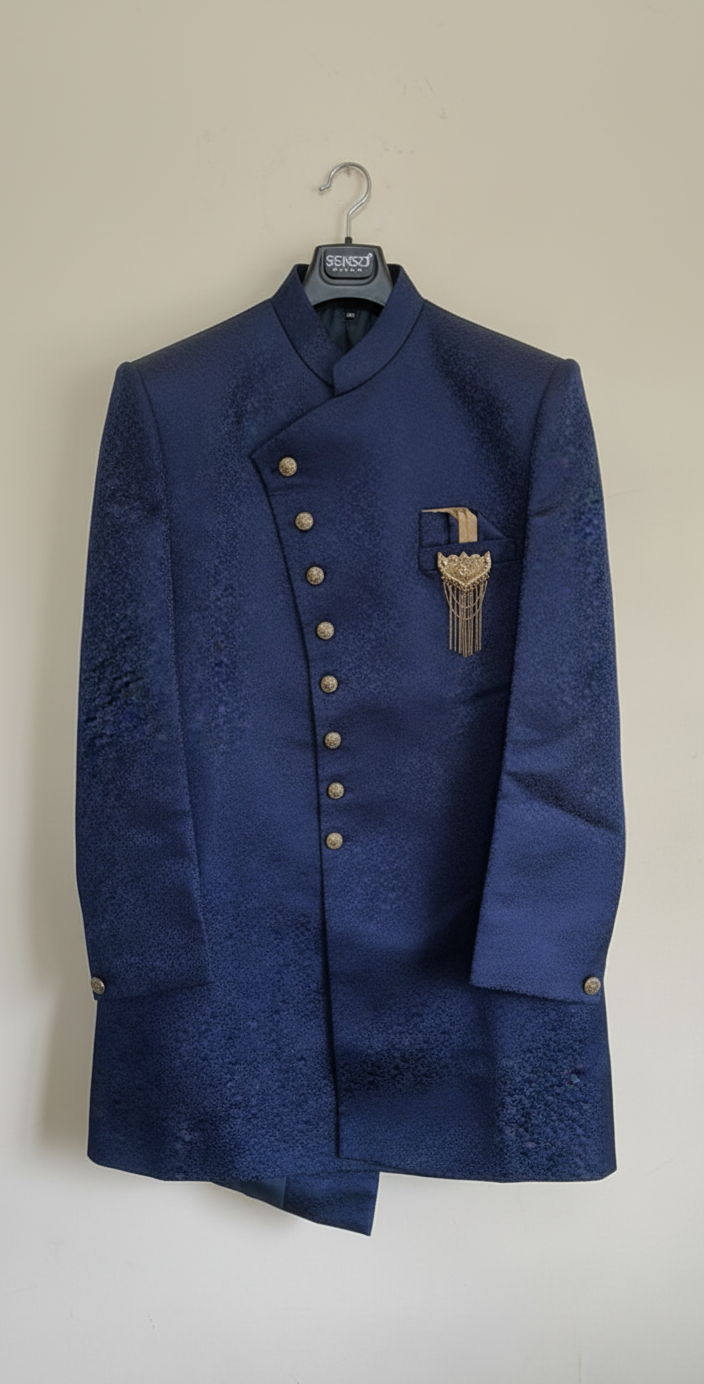 Blue embroidered sherwani jacket on a hanger against a beige wall