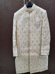 Traditional embroidered sherwani on a hanger against a brown background