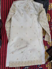 White embroidered garment on a colorful fabric background