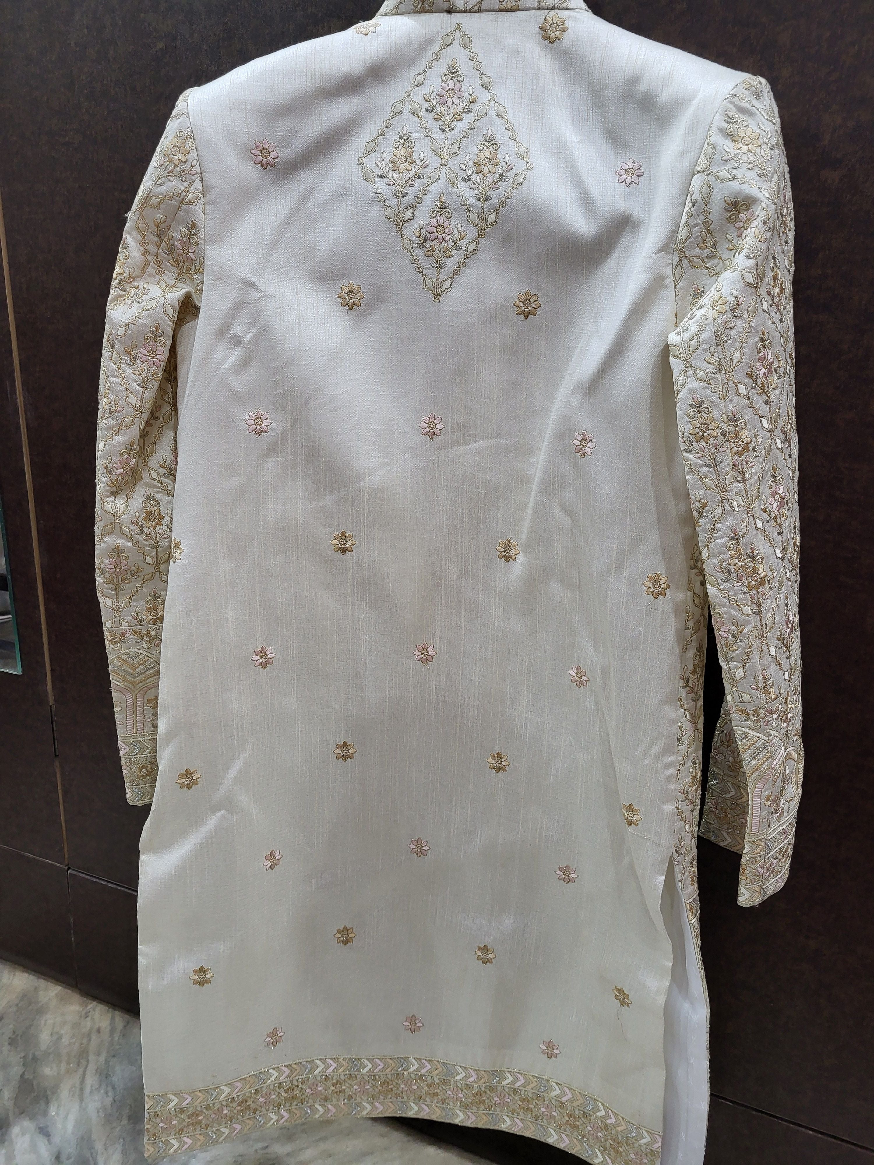 White embroidered traditional outfit on a dark background