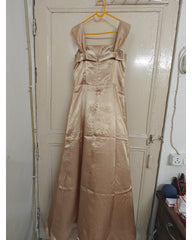 Beige evening gown hanging on a door, back view
