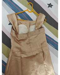 Brown gown on a yellow hanger against a striped background, back view