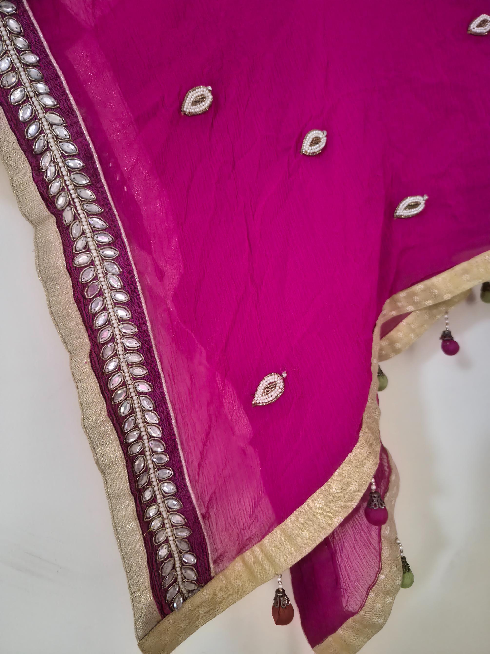 Pink dupatta with gold border and decorative elements on a white background