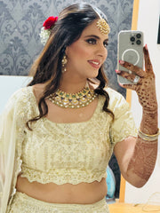 Woman in traditional attire holding a phone with a blurred background