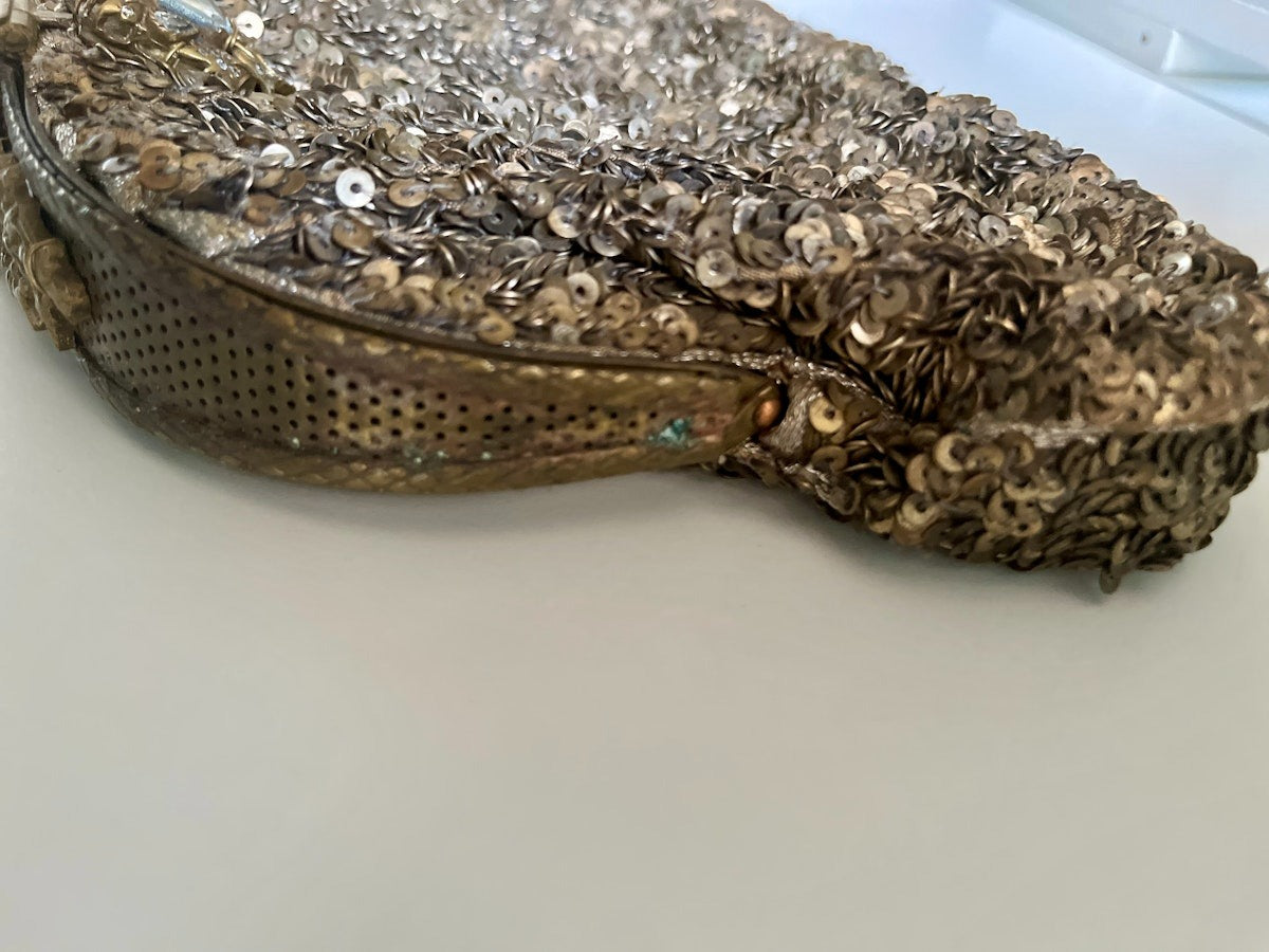 Decorative handbag with sequins and beads on a white background