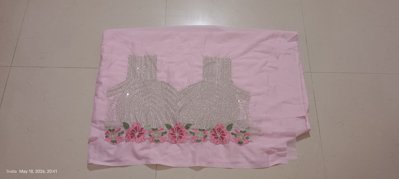 Pink fabric with a pattern of a blouse and flowers on a tiled floor.