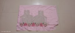 Pink fabric with a pattern of a blouse and flowers on a tiled floor.