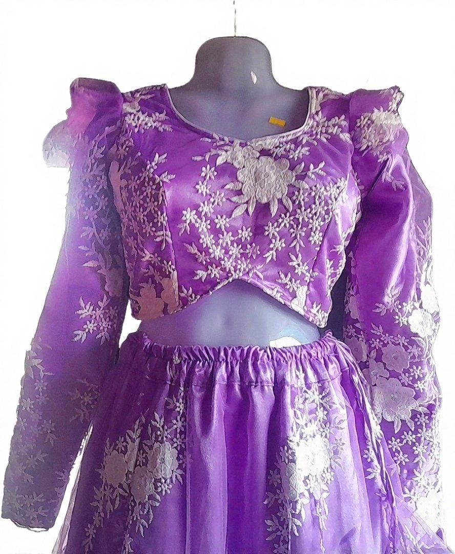 Purple embroidered outfit on a mannequin against a white background