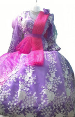 Purple floral dress with a pink sash on a mannequin against a white background