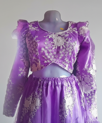 Purple dress with floral patterns on a mannequin against a plain background
