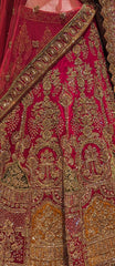 Close-up of a red lehenga with intricate gold embroidery