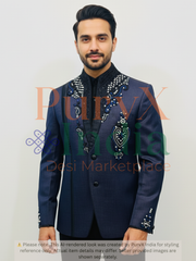Man wearing a navy blue embroidered suit with a white background, featuring the PurnX India logo.