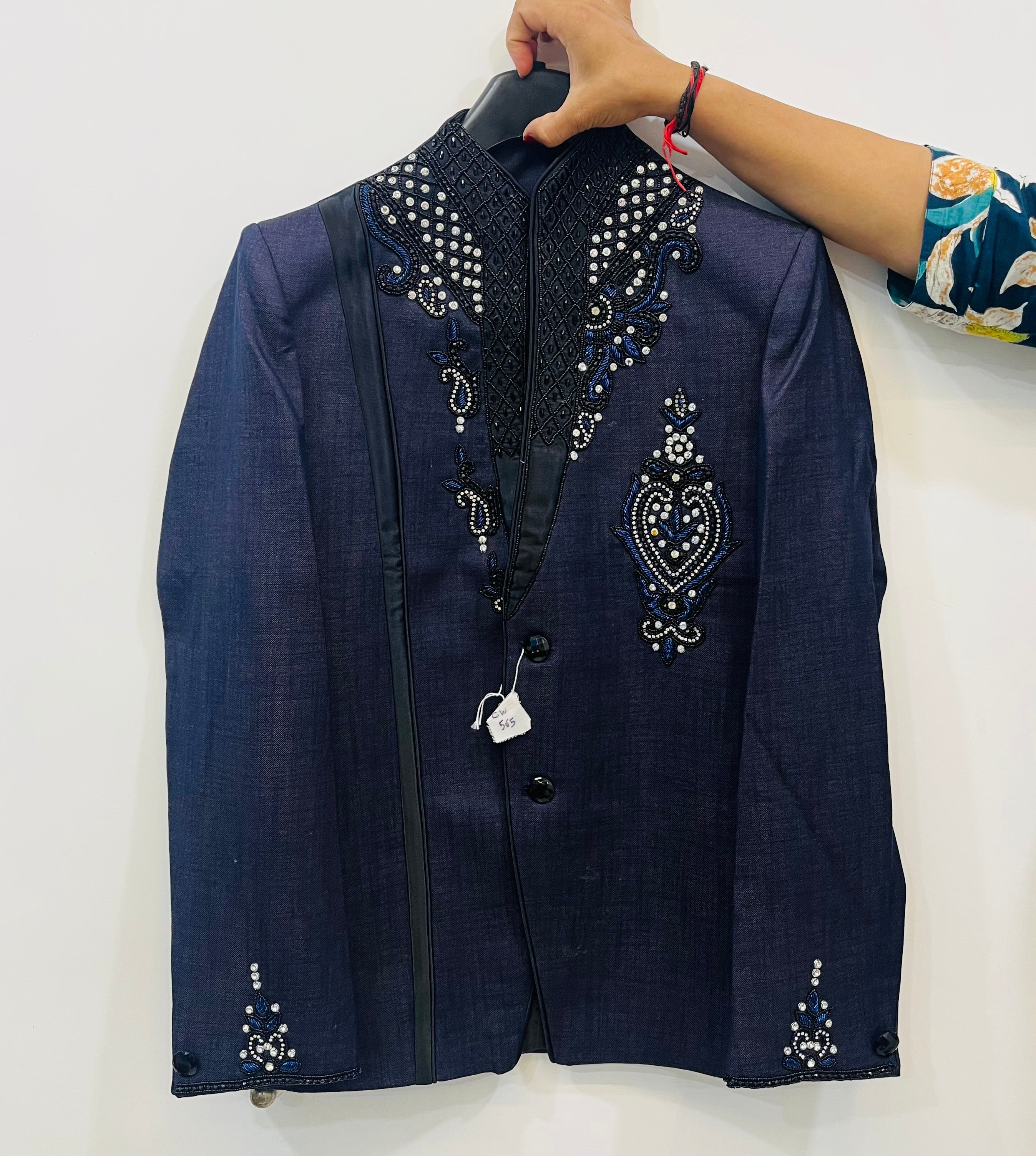 Navy blue embroidered jacket on a hanger against a white background