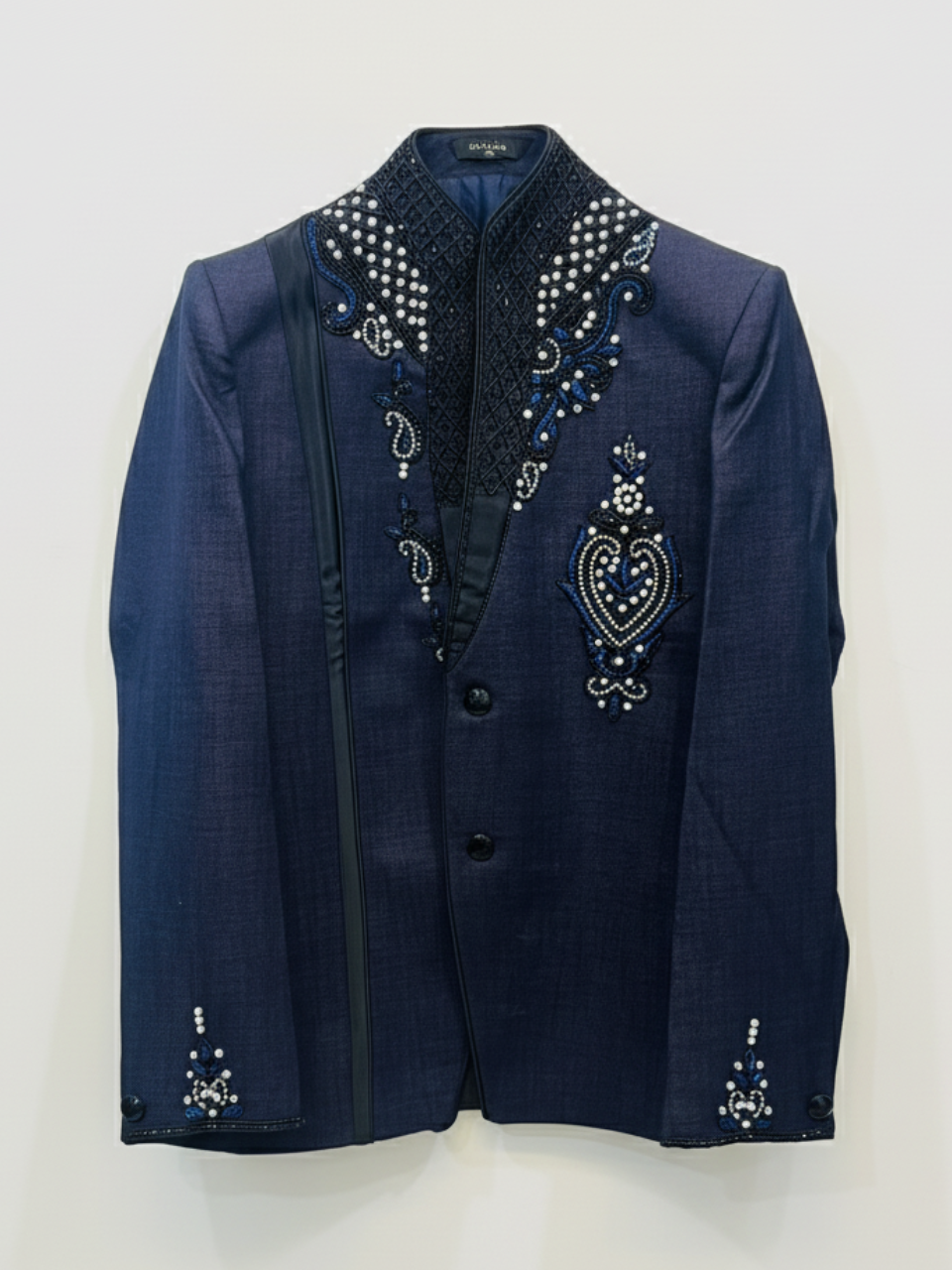 Navy blue blazer with intricate beadwork on a white background
