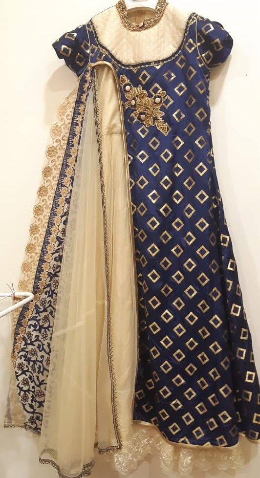 Blue and gold embroidered traditional outfit with a white dupatta on a white background