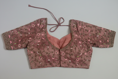 back view of Pink embroidered blouse on a light gray background