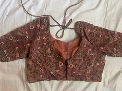 back view of Brown embroidered blouse on a white fabric background