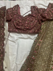 Maroon embroidered blouse with floral patterns on a white fabric background
