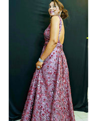 Woman wearing a floral dress against a black background