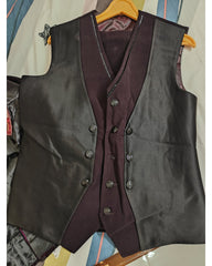 A men's double-breasted waistcoat vest in black satin, layered over a matching dark plum purple vest, hanging on a wooden hanger.