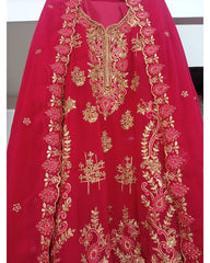 Red garment with gold embroidery on a plain background