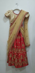 Half Saree with red and gold border on a plain background