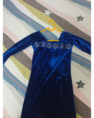 Blue velvet garment with decorative elements on a multicolored striped background
