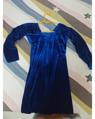 Blue velvet dress on a hanger against a striped background, back view