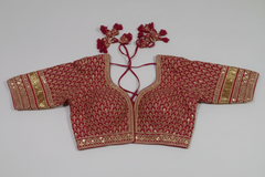 AI generated image of Sayasachi Red embroidered blouse with gold details on a gray background