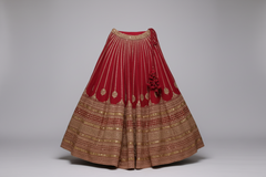 AI-generated image of Sabyasachi Red and gold embroidered traditional lehenga skirt on a gray background.