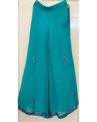 Teal pants with sequin embroidery on a white background