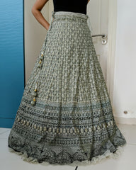 Traditional embroidered lehenga skirt with intricate patterns on a plain background