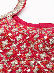 Close-up of a red garment with intricate gold and silver embroidery on a white background