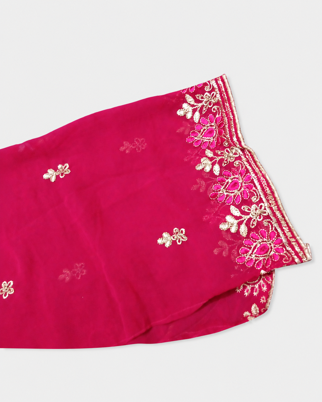 Pink fabric with gold embroidery on a white background