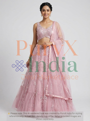Woman wearing a pink lehenga on a light gray background.
