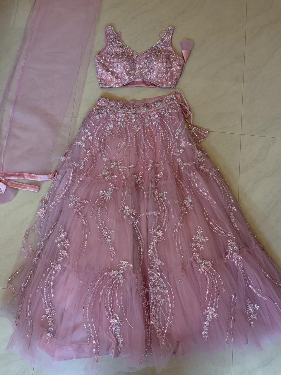 Pink embroidered lehenga on a light floor
