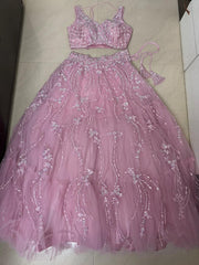 Pink lehenga set with floral embroidery on a tiled floor