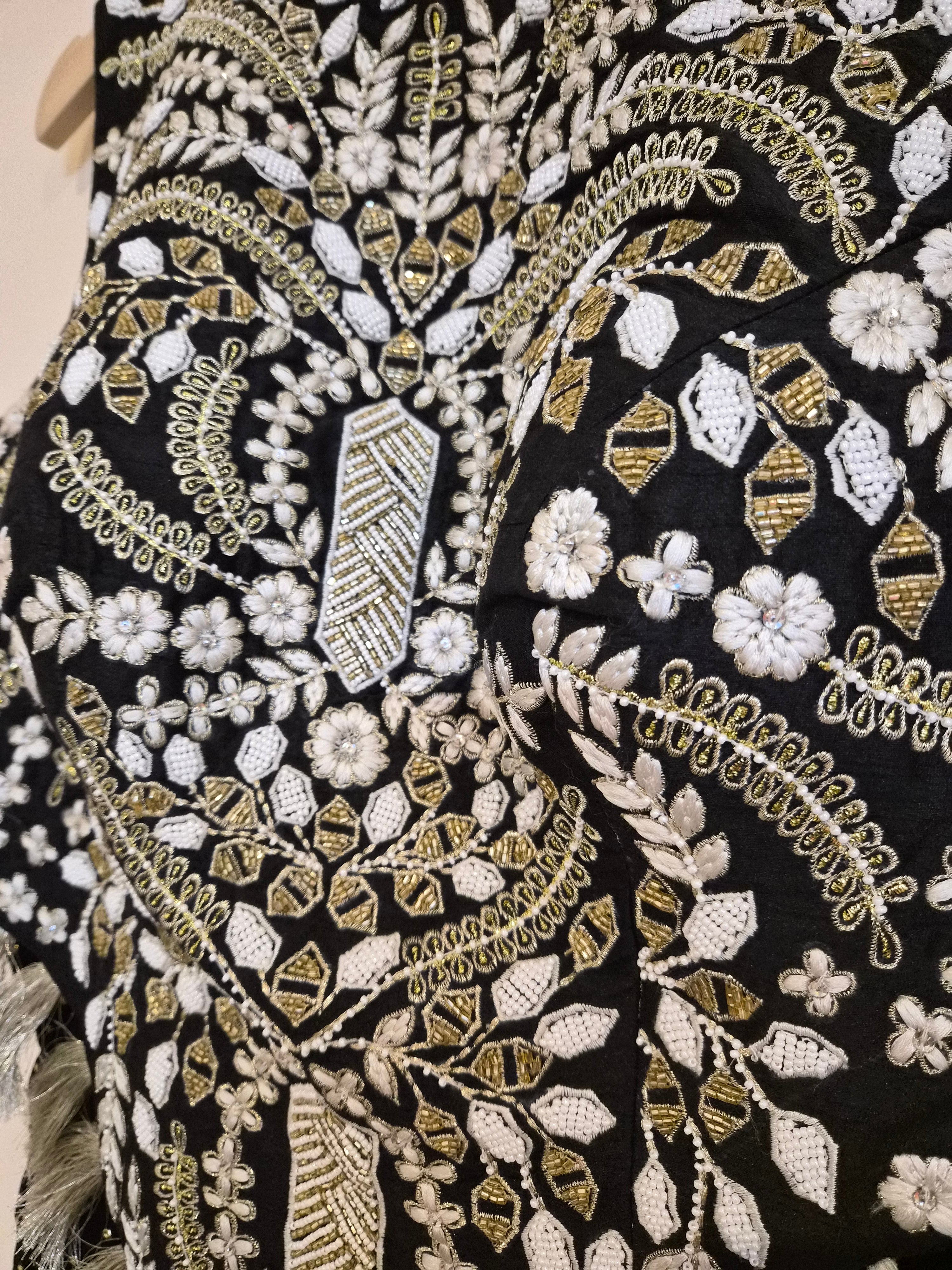 Close-up of black fabric with gold and white embroidery