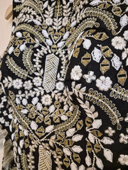 Close-up of black fabric with gold and white embroidery