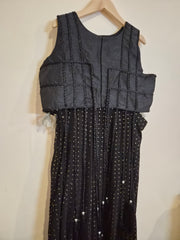 Black dress with quilted design on a light background