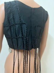 back view of Black sleeveless top with fringe details on a plain background