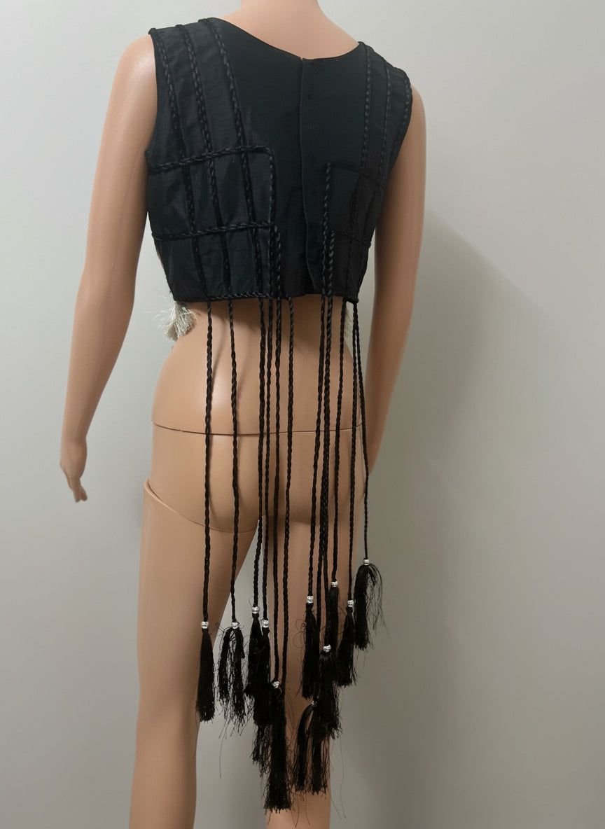 back view of Black fringe top on a mannequin against a white background